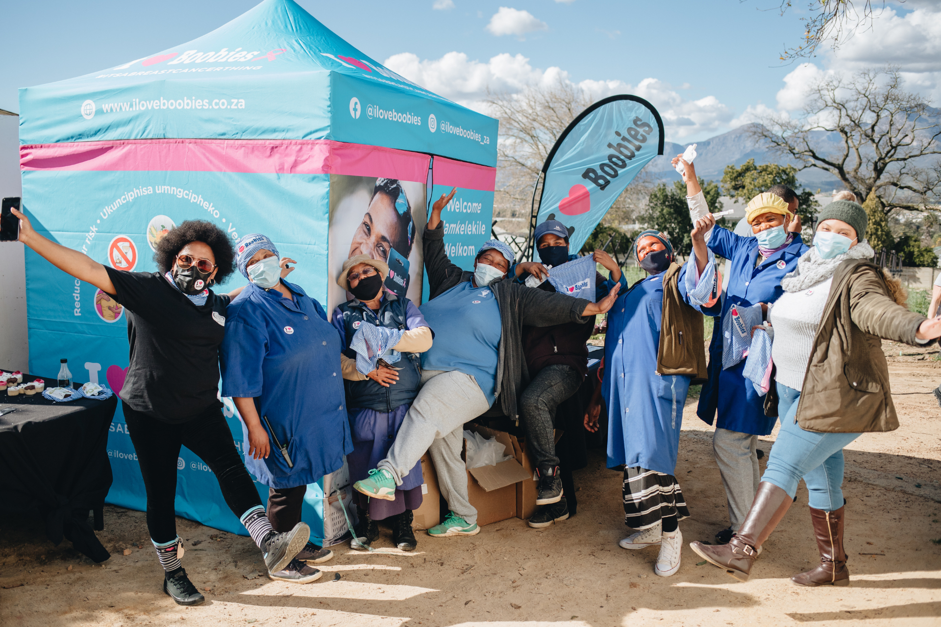 Volunteers and nurses celebrating at a screening event
